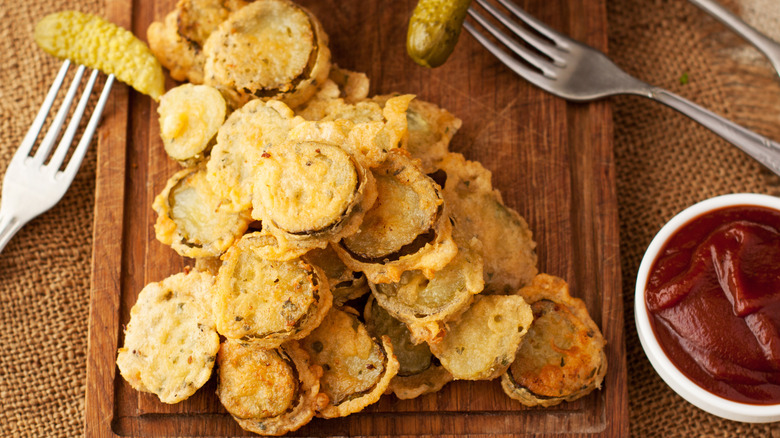 fried pickles on wood board