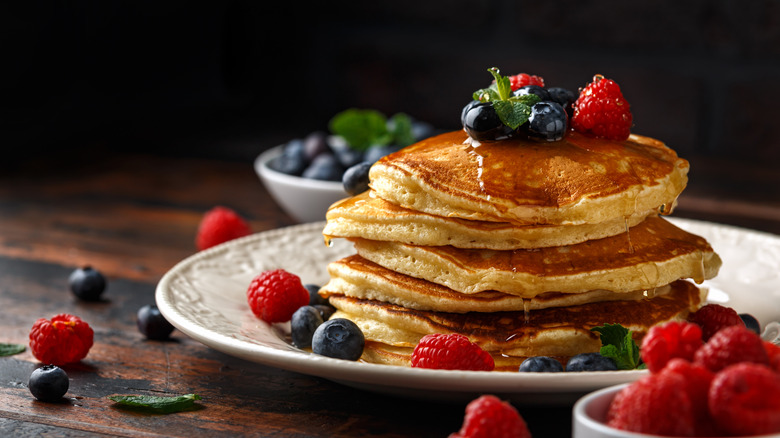 stack of fluffy buttermilk pancakes with berries