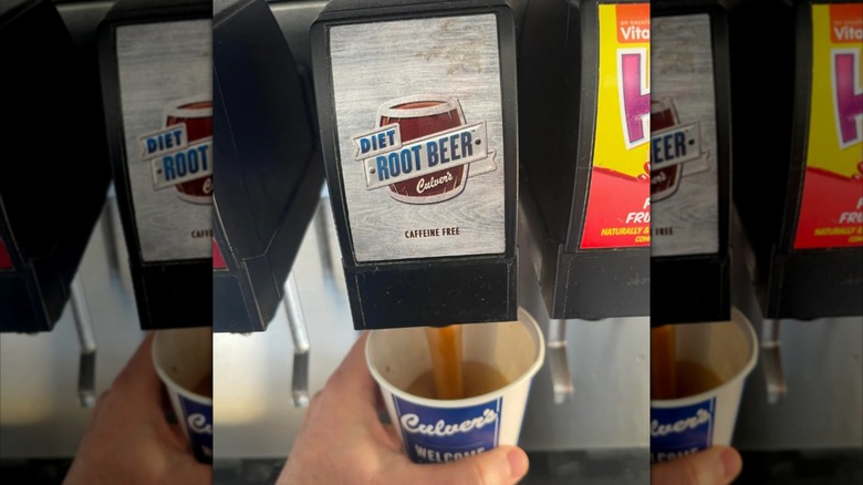 A customer fills a Culver's cup with diet root beer from a self-serve dispenser