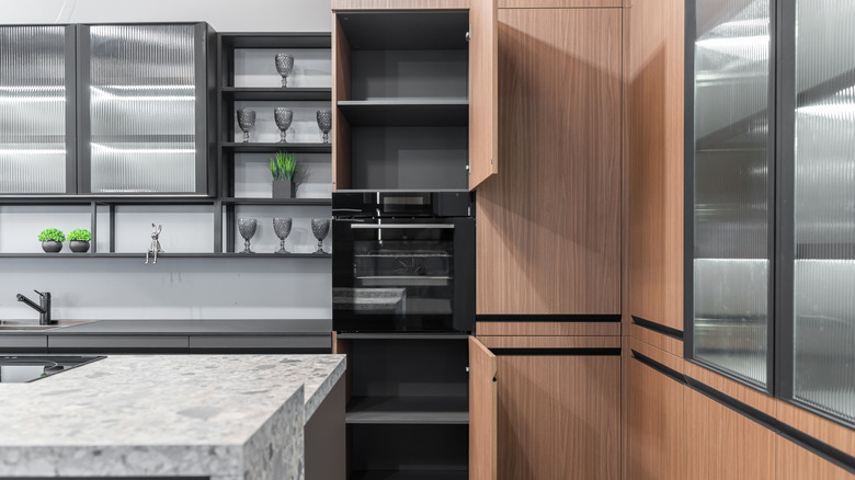 various styles of kitchen cabinet in a new mostly empty kitchen
