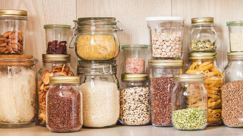 Stacked assorted glass jars of dried goods