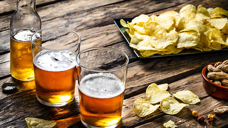 glasses of beer and potato chips