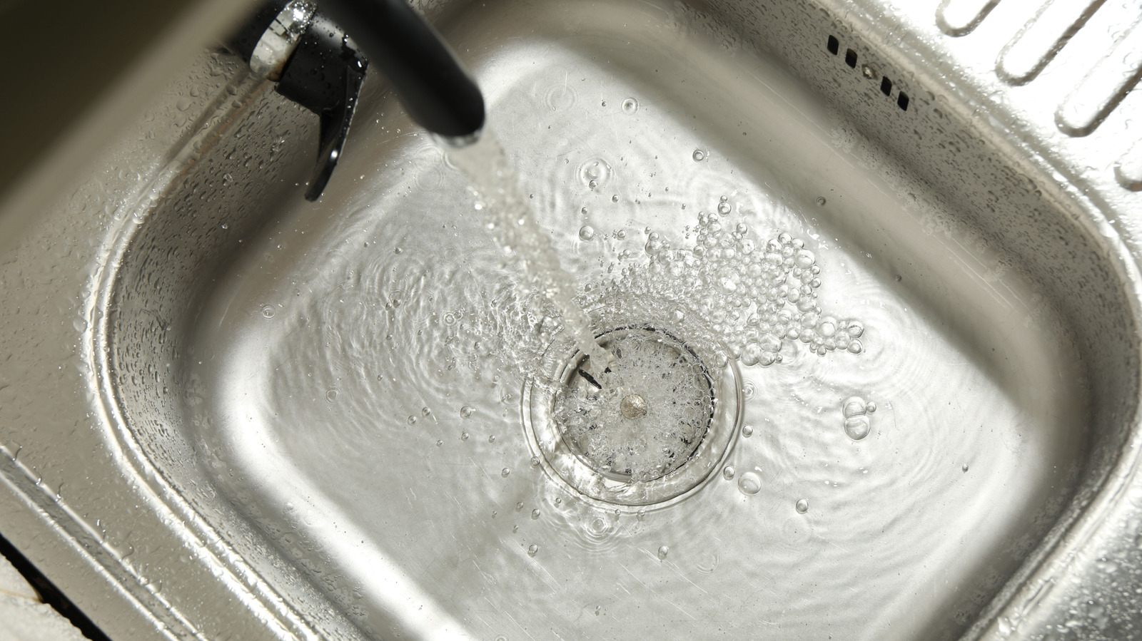 The Sneaky Kitchen Habit That Can Jam Your Sink Over Time - Tasting Table