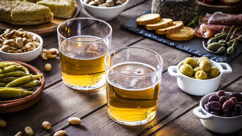 glasses of beer with bar snacks