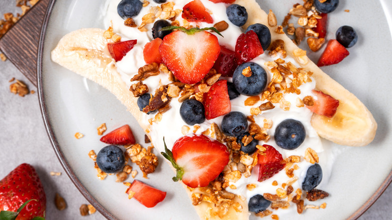 A breakfast banana split with berries, granola, and yogurt