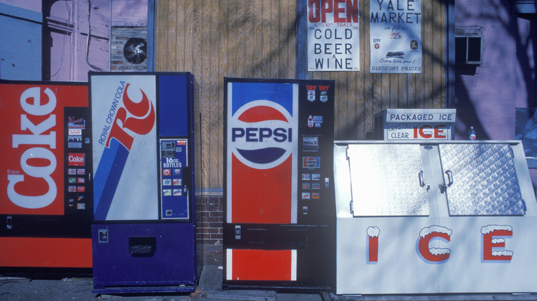 Vintage Coke, RC, and Pepsi vending machines outside of market