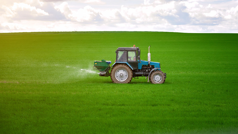 tractor fertilizing a field