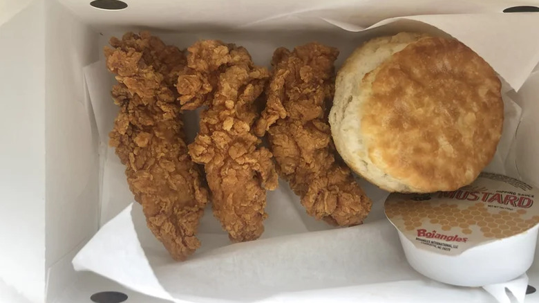 An order of Bojangles chicken tenders with a biscuit.
