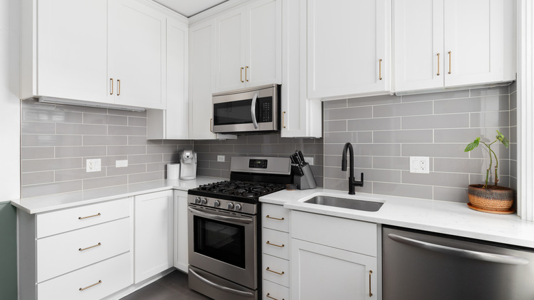 A kitchen is pictured with appliances and storage space