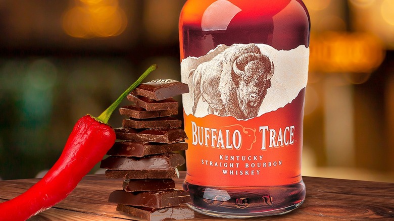 bottle of Buffalo Trace bourbon with stack of chocolates and chili pepper