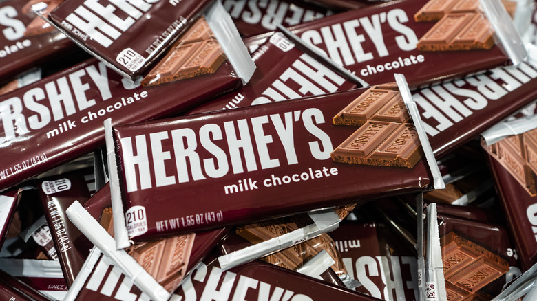 a pile of Hershey's milk chocolate bars in wrappers