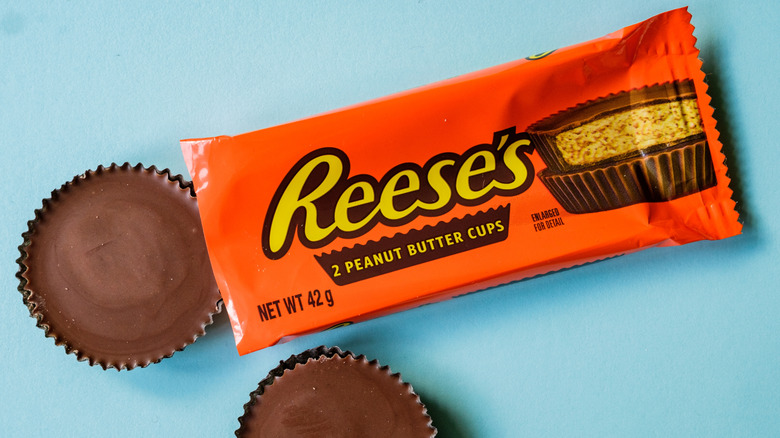 an orange Reese's package with two cups outside