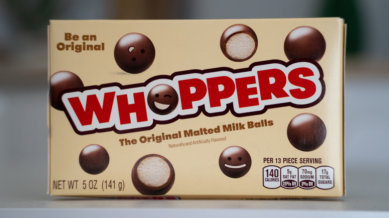 a tan box of Whoppers with red text