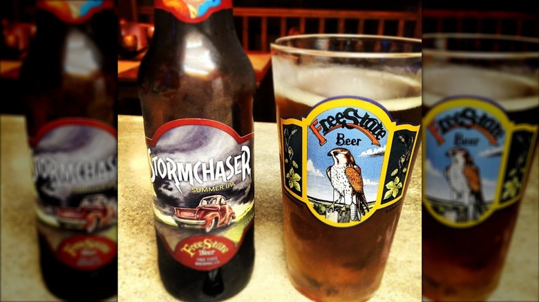 A bottle of Stormchaser IPA next to a Free State Brewing Co. branded pint glass
