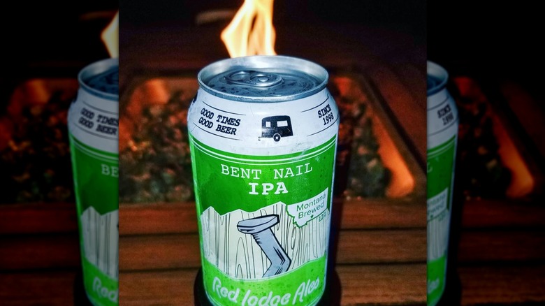 Can of Bent Nail IP in front of a barbeque pit.