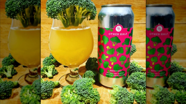 Glass and can of Broccoli IPA and several heads of fresh broccoli.