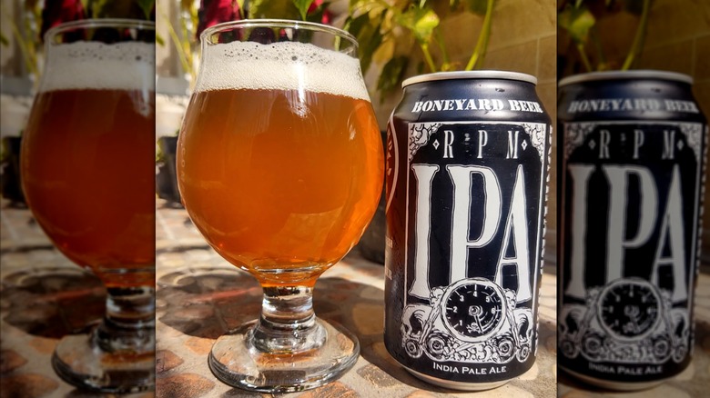 Black can of RPM IPA next to a filled beer glass.