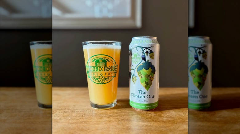 Tilted Barn Brewery branded glass filled with beer next to a can of Chosen One IPA.