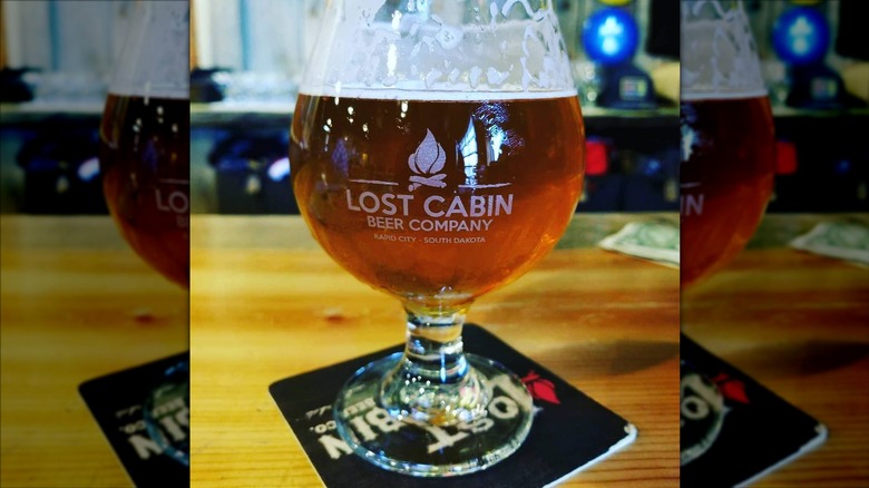 Glass of SoDank IPA in a Lost Cabin Brewing Co. branded glass.