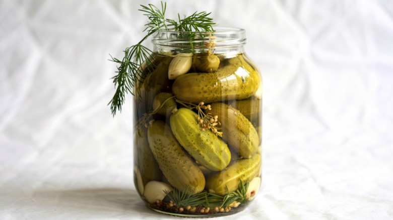 jar of pickles with herbs a