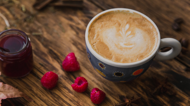 Latte in mug with raspberries