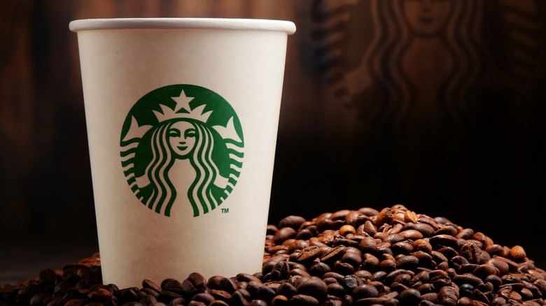Starbucks cup and coffee beans