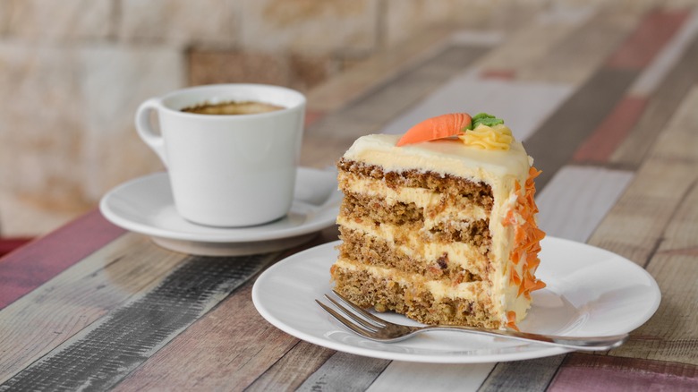 carrot cake next to hot coffee latte