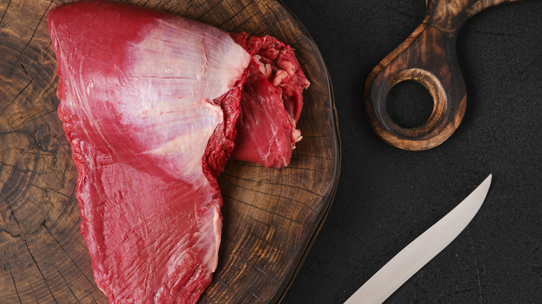 Raw ribeye cap on a chopping board