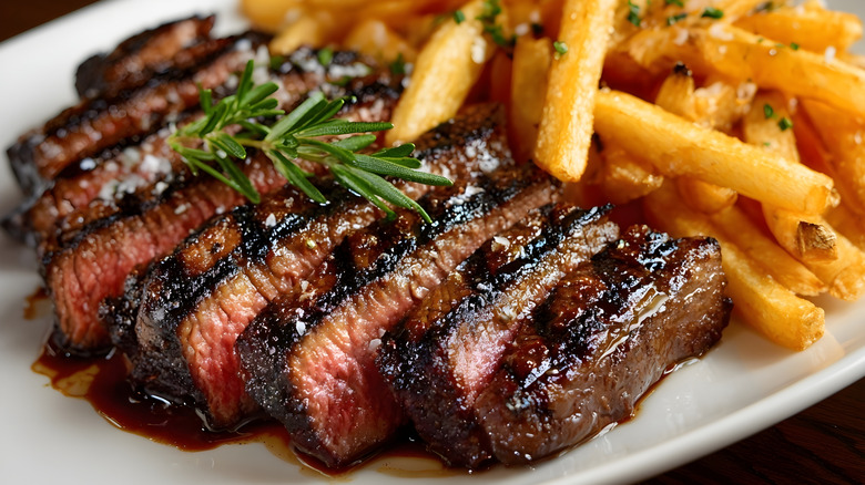 Sliced steak on a plate with fries