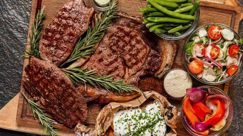 grilled steaks with an assortment of sides