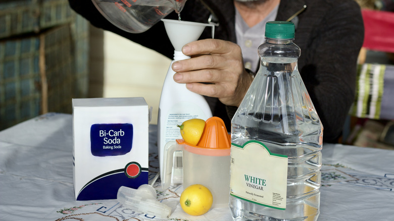 A man making a cleaning solution of baking soda and vinegar
