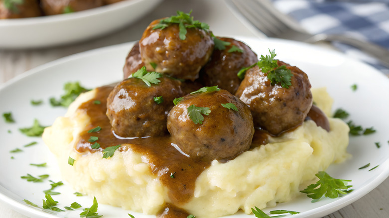 gravy covered meatballs on mashed potatoes