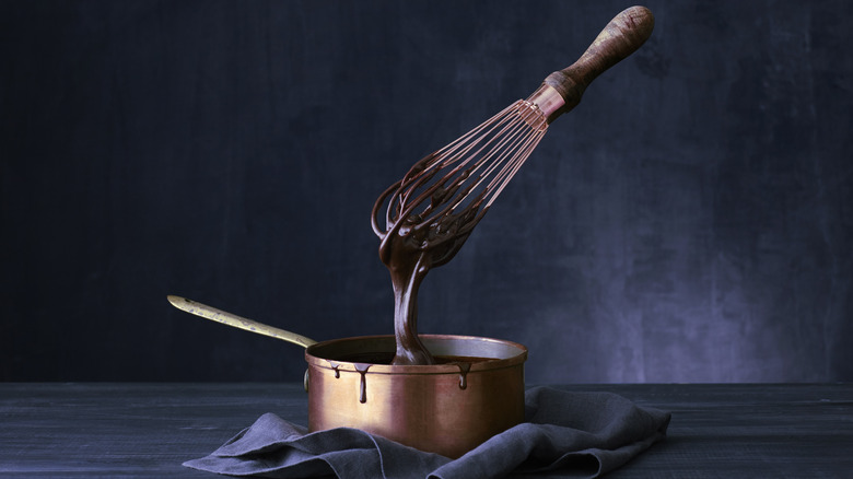 copper whisk dripping chocolate