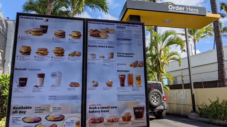 A hand gripes a McDonald's cheeseburger