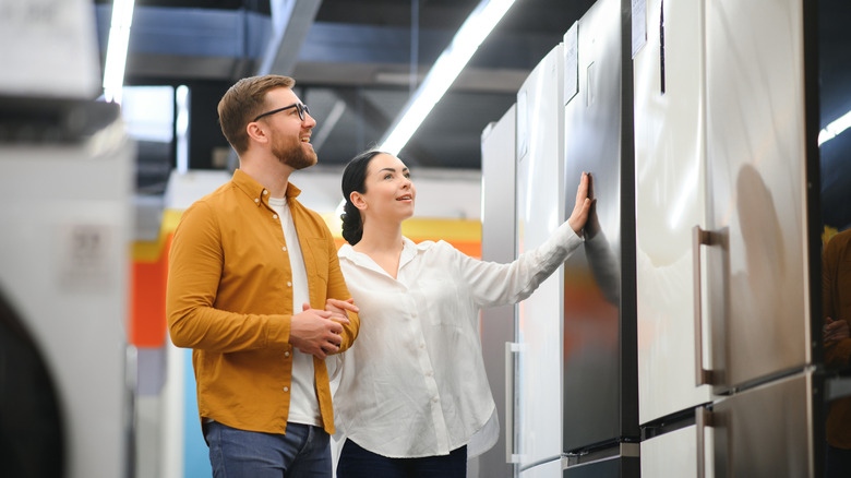 couple shops for new fridge at appliance store