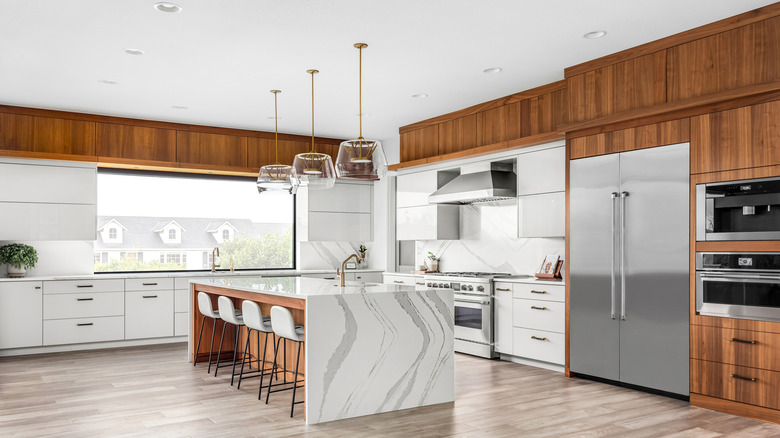 a modern open kitchen with counter-depth fridge