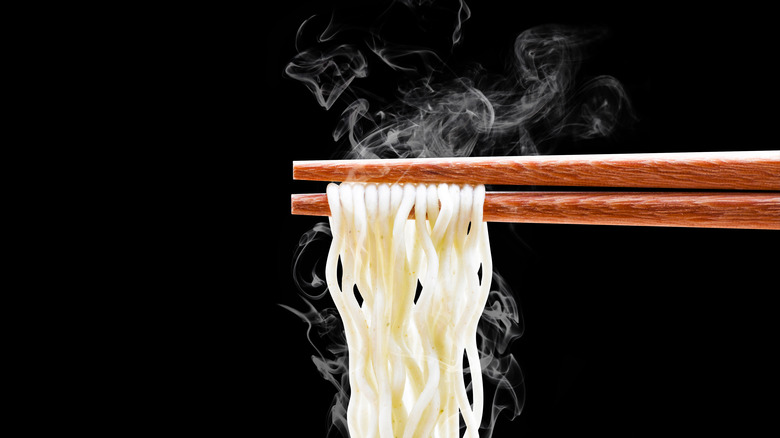 Closeup of noodles on chopsticks