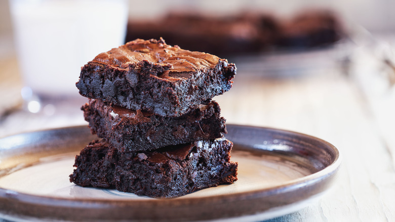 three brownies stacked on plate