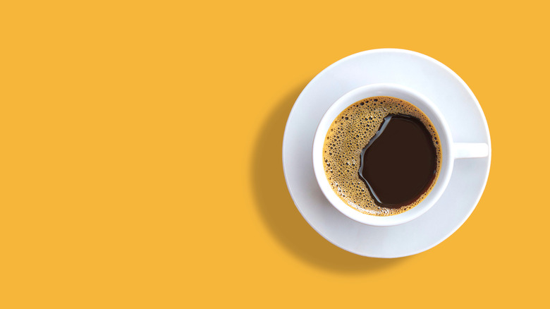 cup of coffee against a yellow background