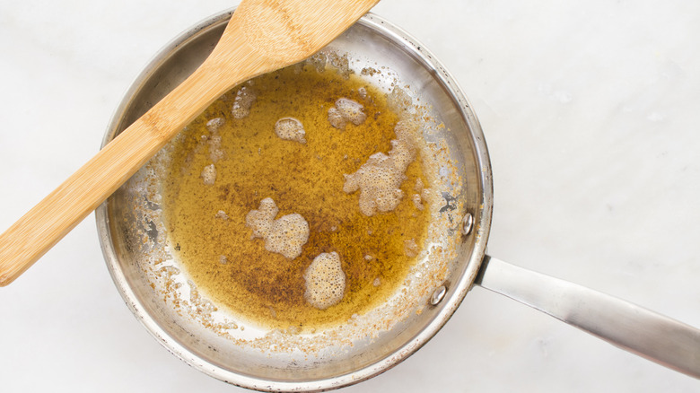 browned butter in a skillet with wooden spoon