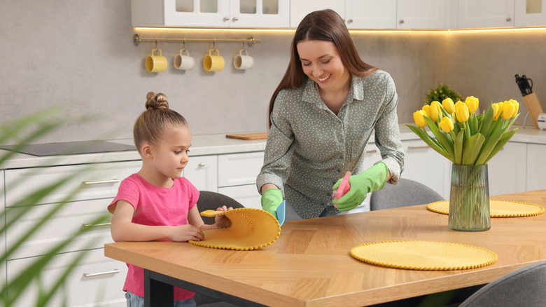 Parent and child cleaning kitchen