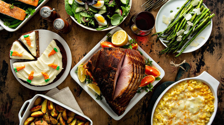 Country style meal with ham, mac and cheese, carrot cake, asparagus, salad, and roasted potatoes