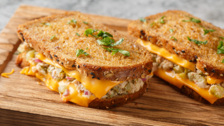 tuna melt on wooden board with herbs