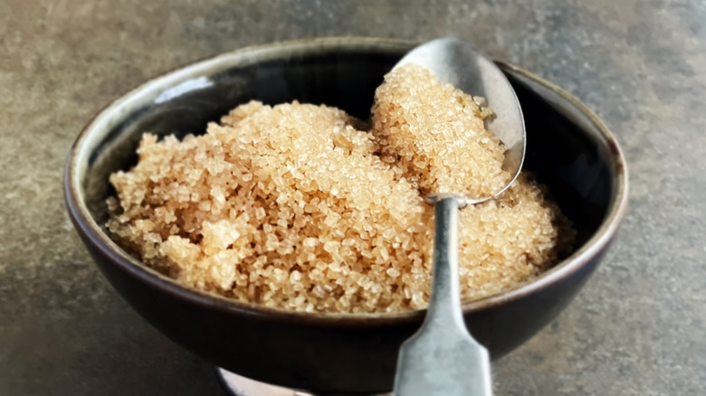 Close-up of brown sugar in a bowl with spoon
