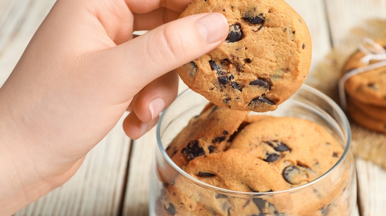 hand getting cookie from jar