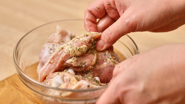 Marinating chicken in a bowl