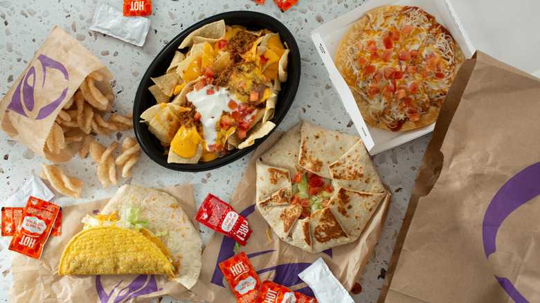 assortment of taco bell food with sauce packets