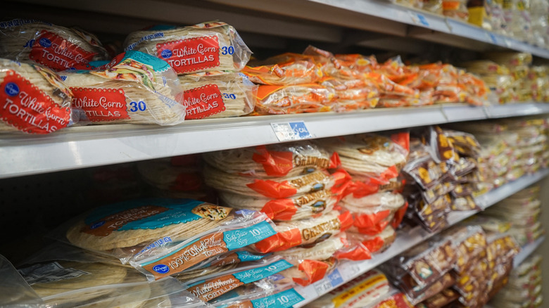 Bags of shelf-stable tortillas lined on a grocery store shelf