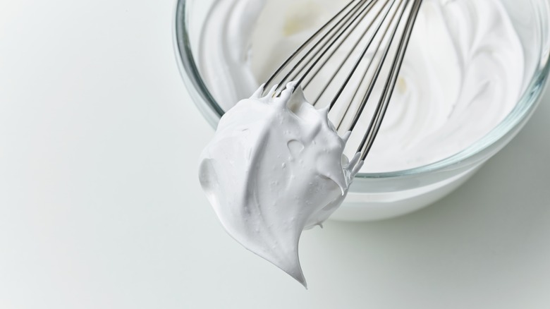 whipped cream hanging off a whisk