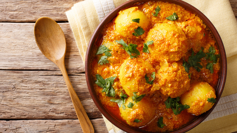Dum aloo in a bowl with spoon